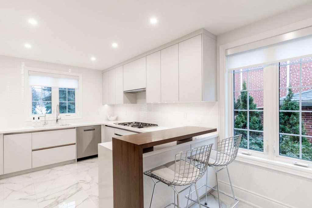 Modern white custom kitchen cabinets with walnut island
